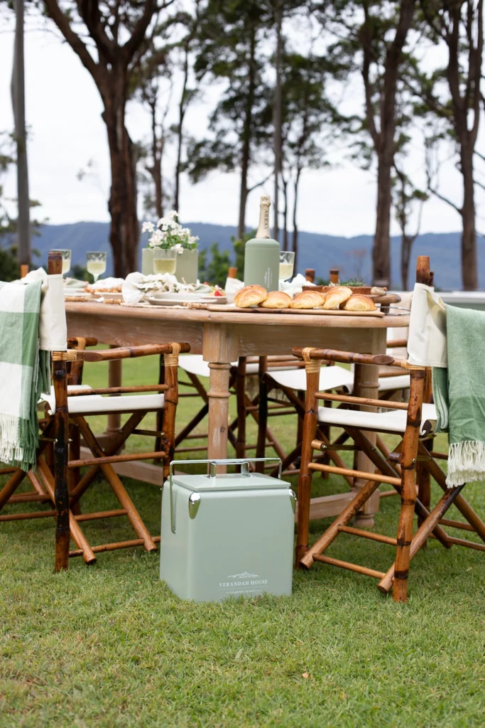 Rustic outdoor dining table styled for a high‑tea brunch on the estate lawn