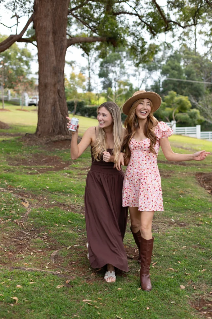 	Friends laughing and strolling across the grounds after lawn games