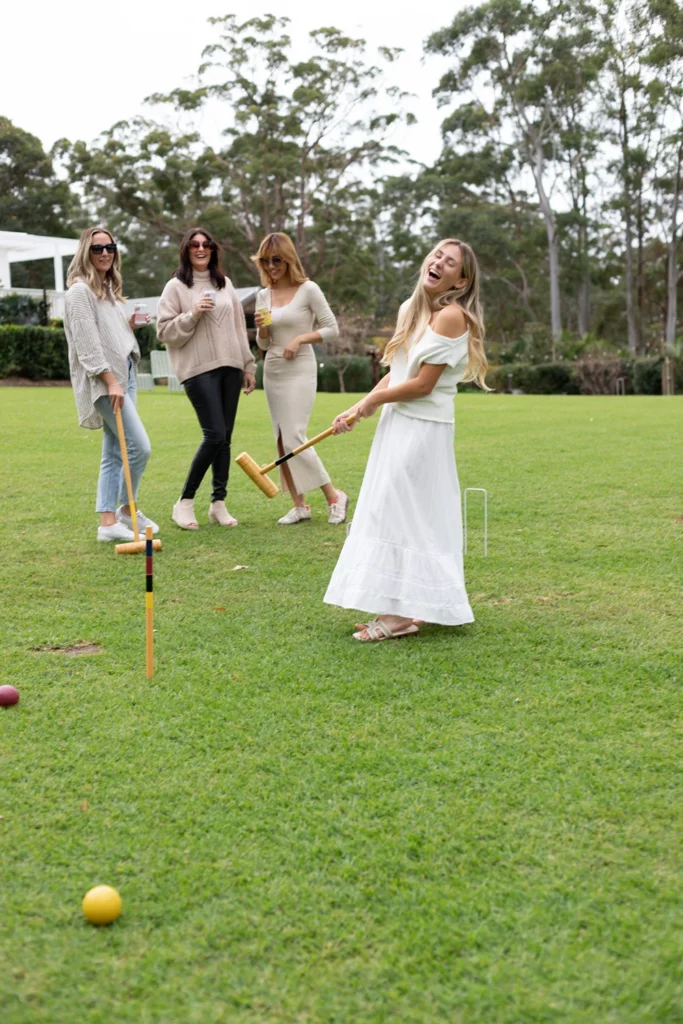 Women playing croquet on the lawn bowls green at the estate