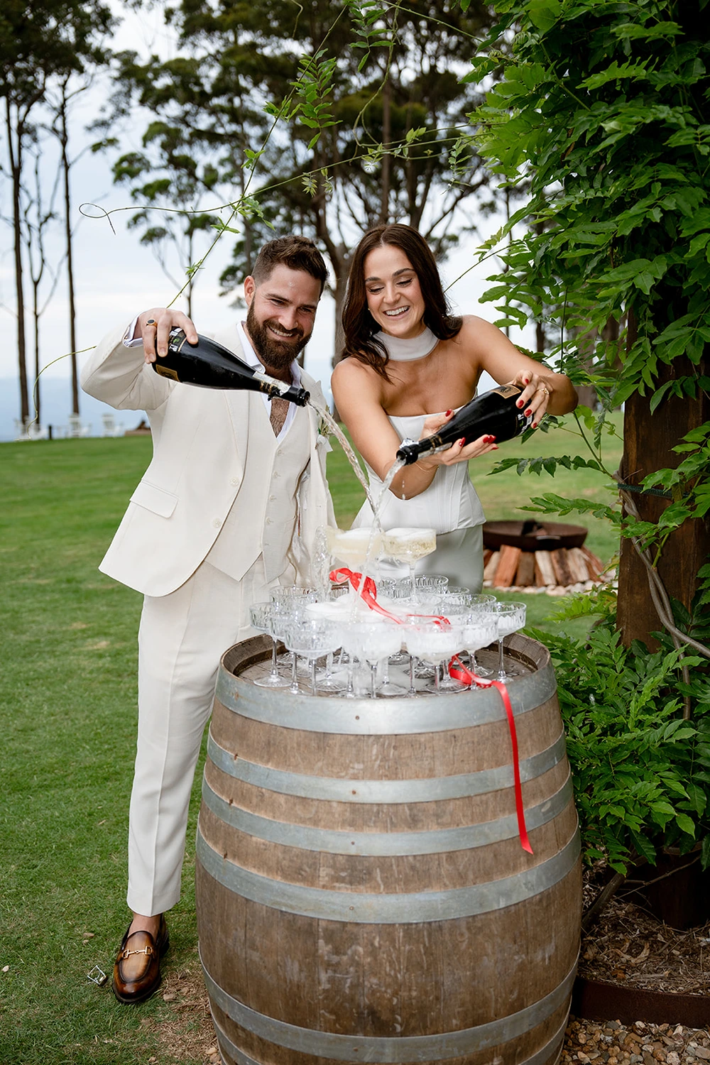 Newlyweds pouring champagne during their elopement celebration at Verandah House